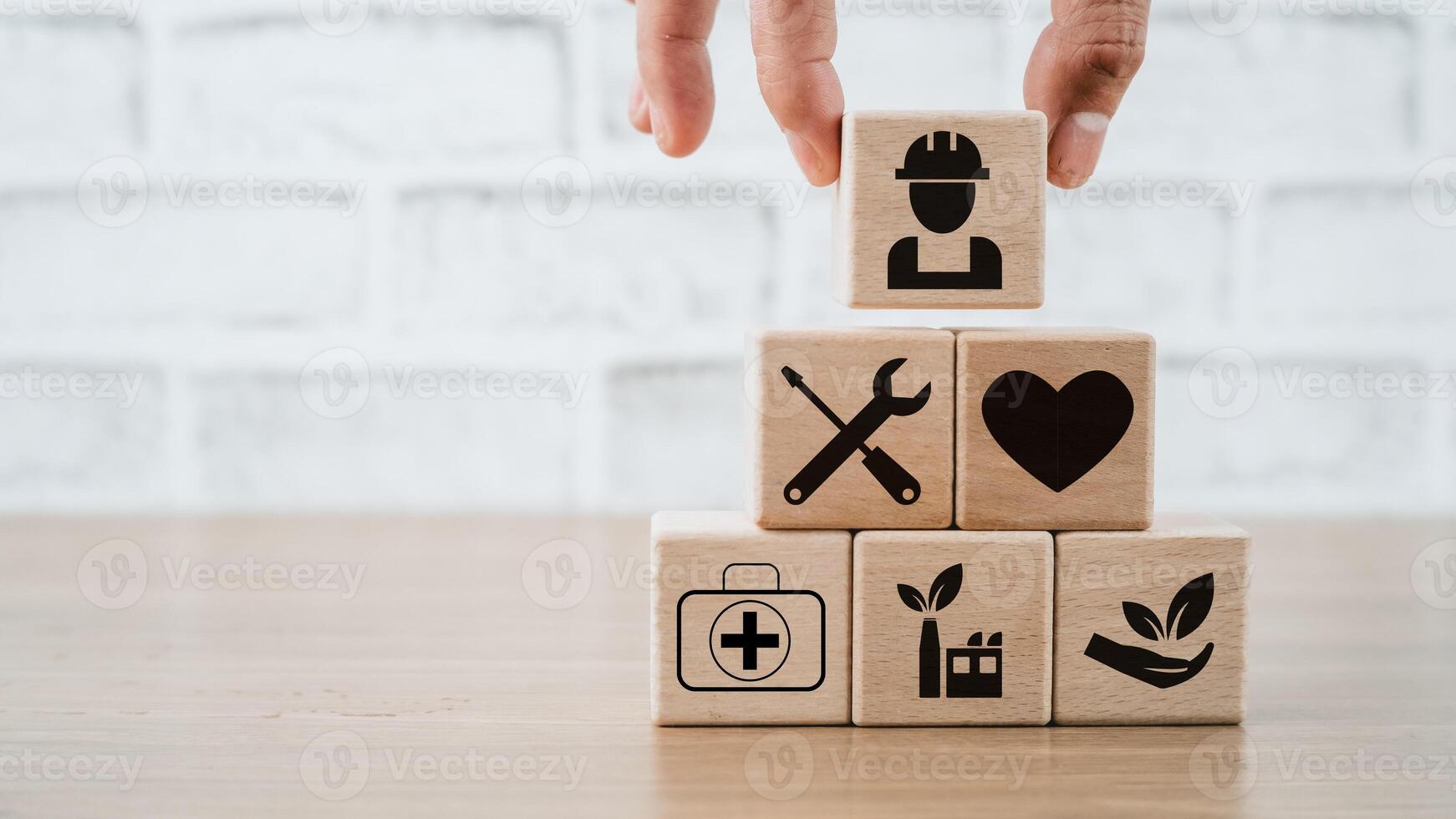 Health safety environment HSE education industry Concept, Man hand holding wooden cube block with Health safety environment icon with copy space. photo