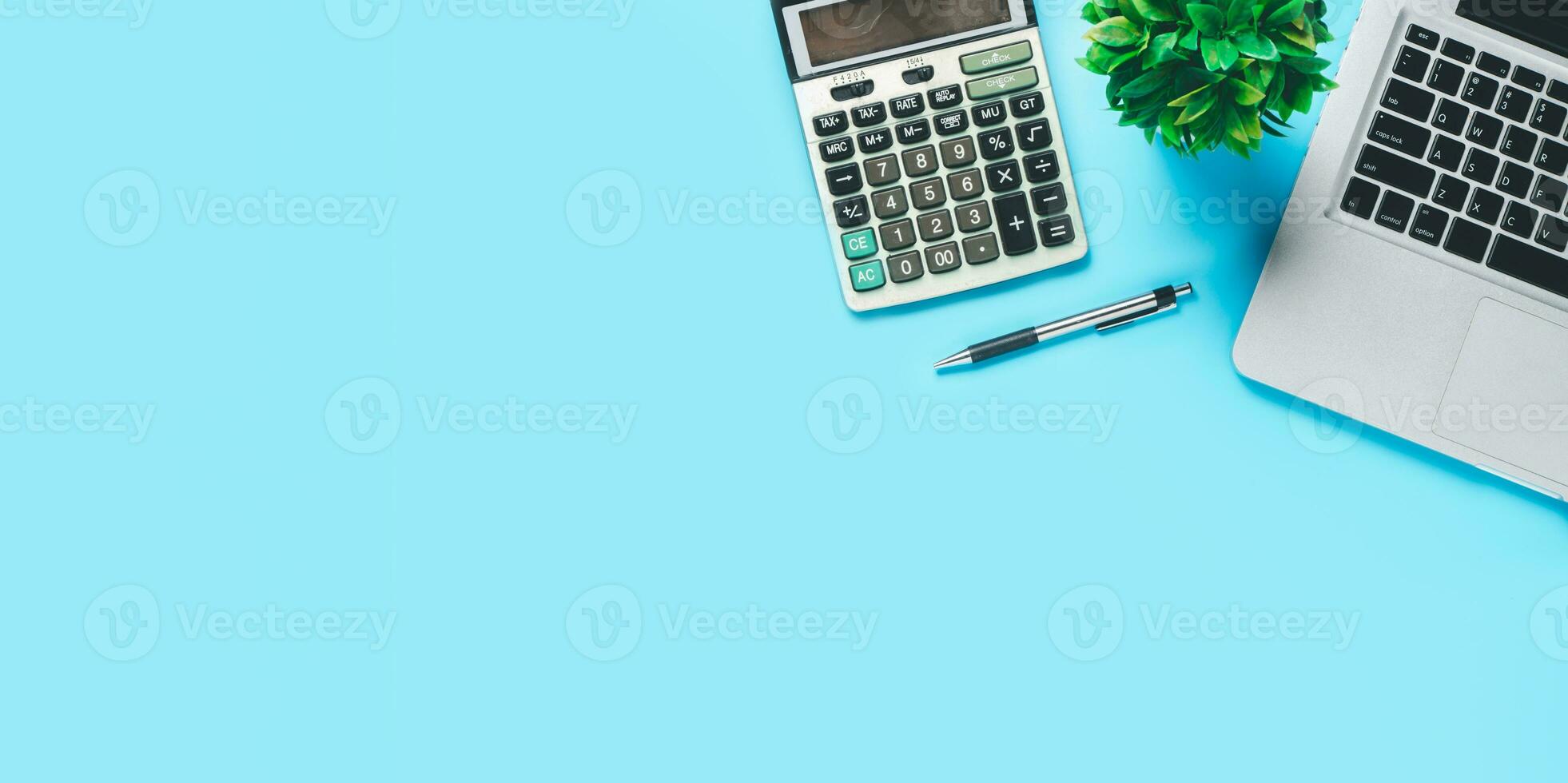 Top view, Blue Office desk with computer, pen and calculator, copy space, Mock up.. photo