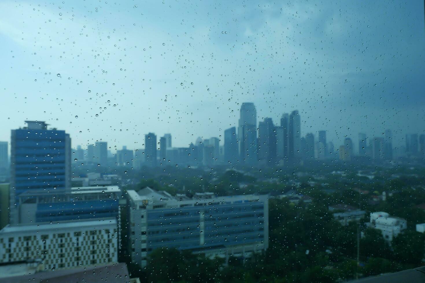 Raindrops on the windows of the 13th floor building photo