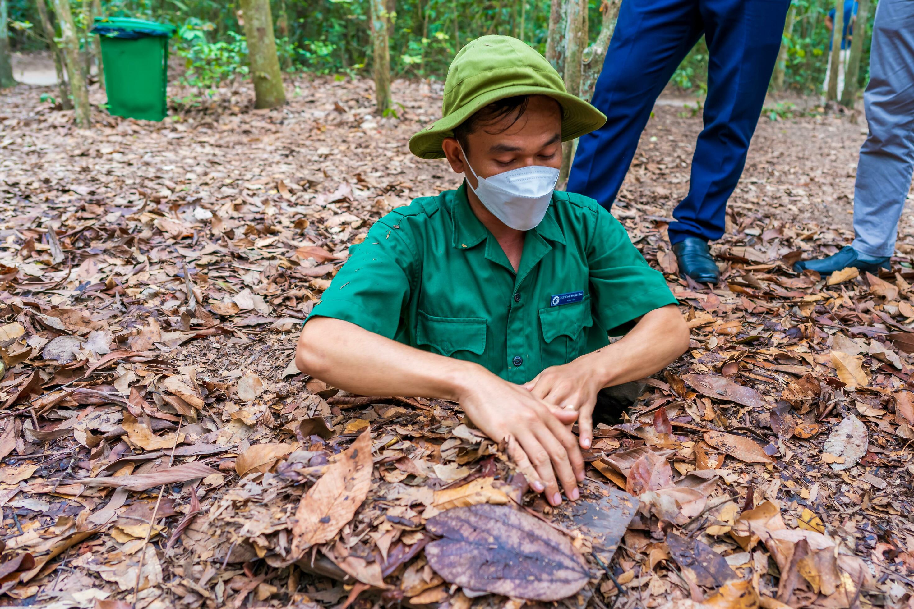 The Cu Chi tunnels. A guide demonstrating how a Vietcong hide into the