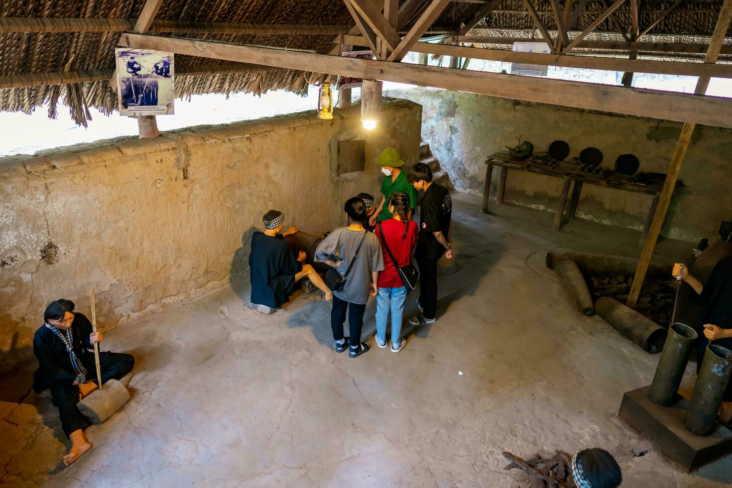 The Cu Chi tunnels.  The tour guide is showing the weapon making site. Famous tourist attraction in Vietnam. Stock photo