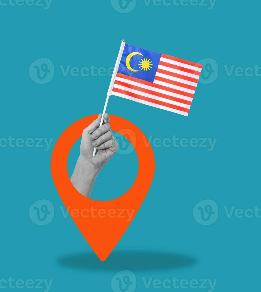 Art collage, Hand with Malaysian flag on blue background with navigation icon. photo