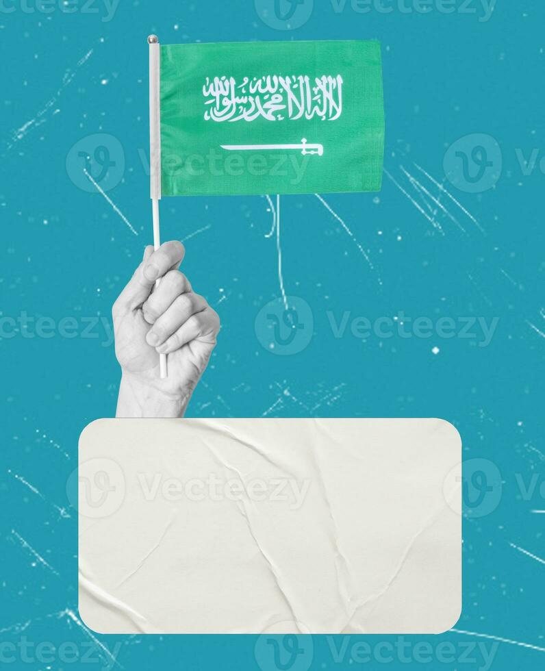 Art collage, Hand with Saudi flag on a blue background, with space for text. photo