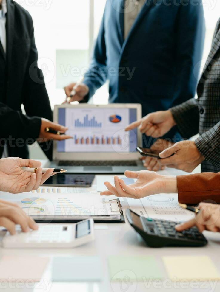 Businessman and team analyzing financial statement Finance task. with smart phone and laptop and  tablet. Wealth management concept photo