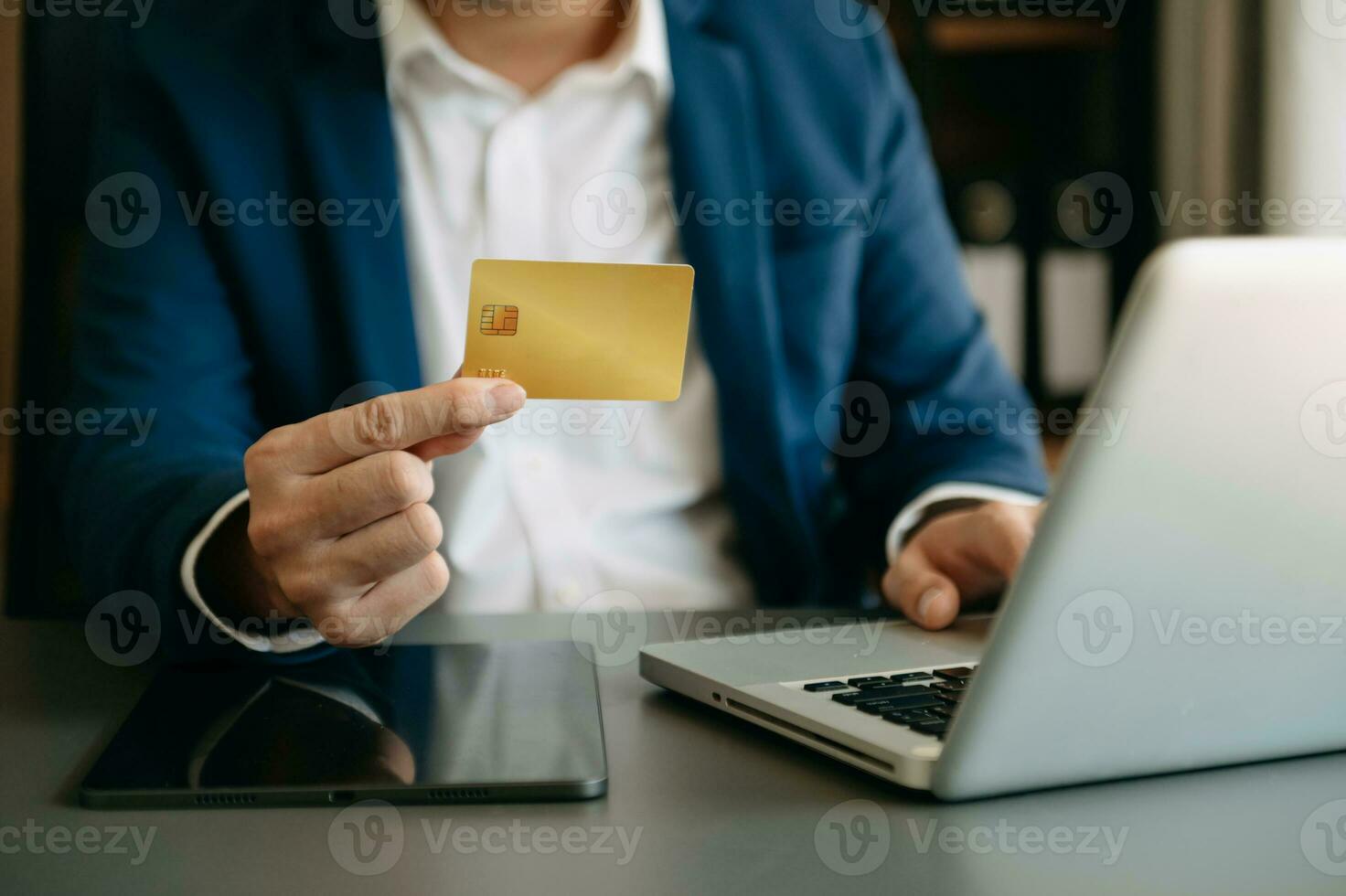 Man using smart phone for mobile payments online shopping,omni channel,sitting on table,virtual icons graphics interface screen photo
