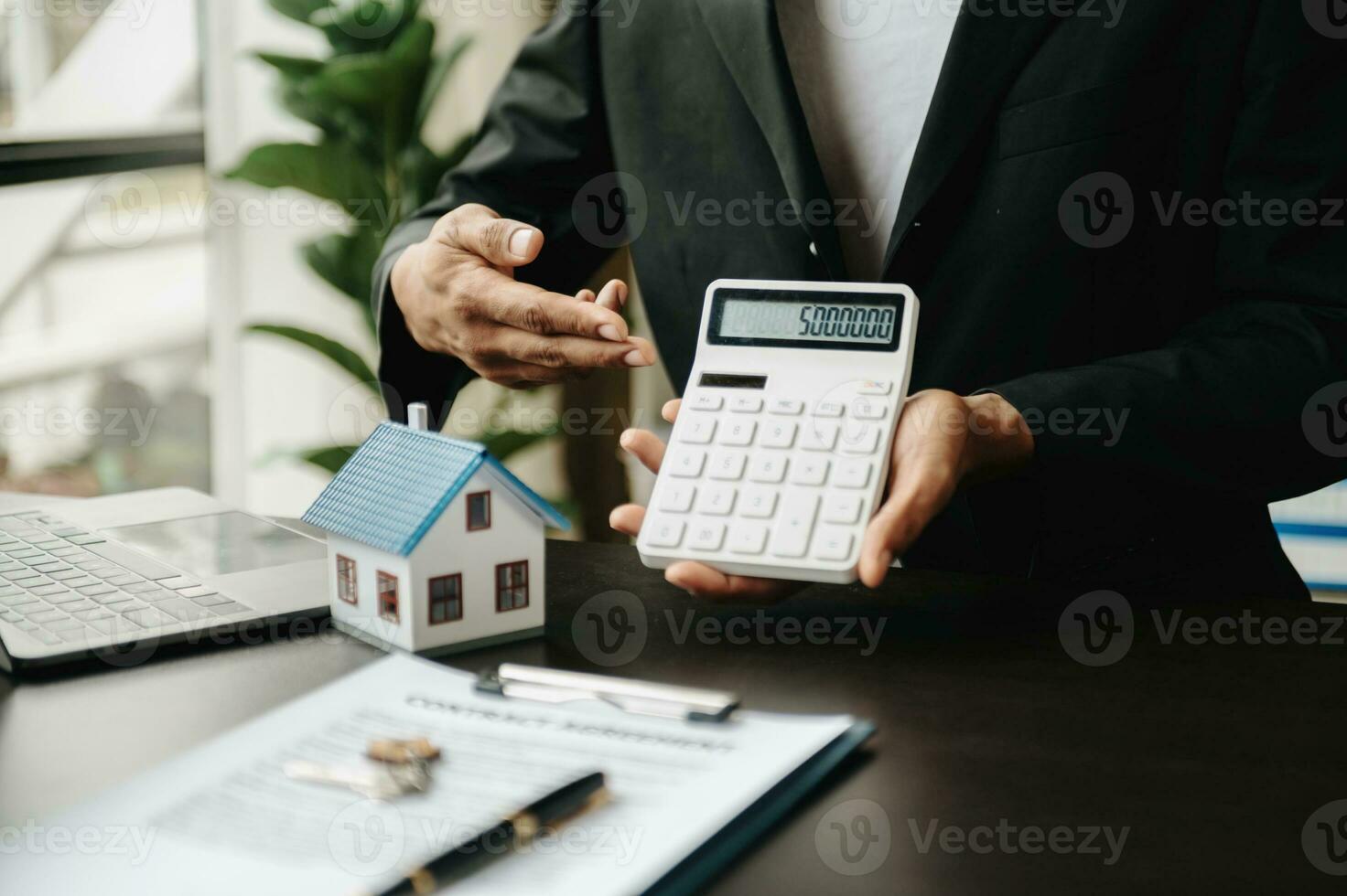 Salesman Hands On House Model , Small Toy House Small Mortgage Property insurance and concepts real estate photo