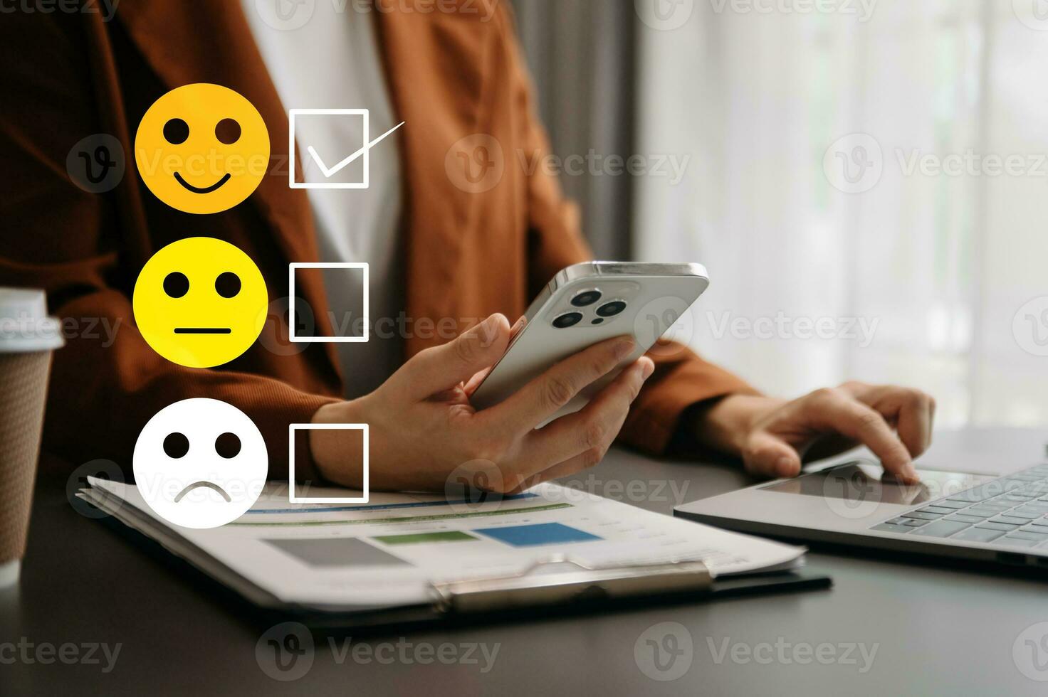 Customer service evaluation concept. woman Show face smile emoticon show on virtual screen from hand.looking at smart phone, tablet and laptop in office photo