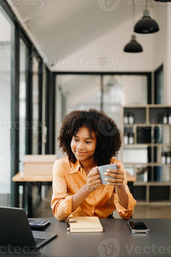 Business woman using tablet and laptop for doing math finance on an office desk, tax, report, accounting, statistics, and analytical research concept in office photo