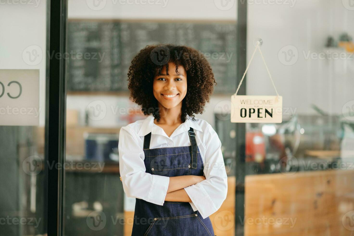 Startup successful small business owner sme African woman stand with tablet  in cafe restaurant. woman barista cafe owner. photo