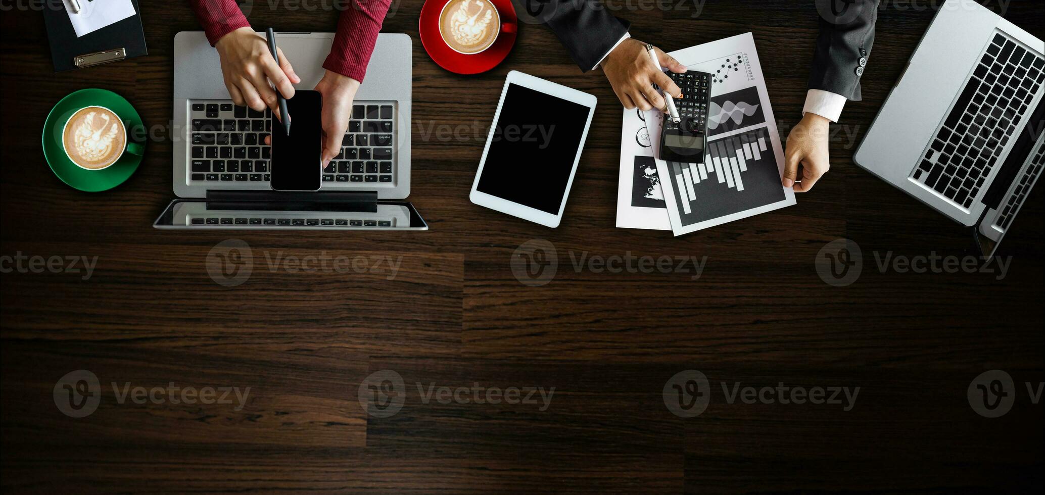 Top view of business Group of Multiethnic Busy People meeting with other in modern office with laptop computer, smartphone, tablet, coffee and document on table. photo