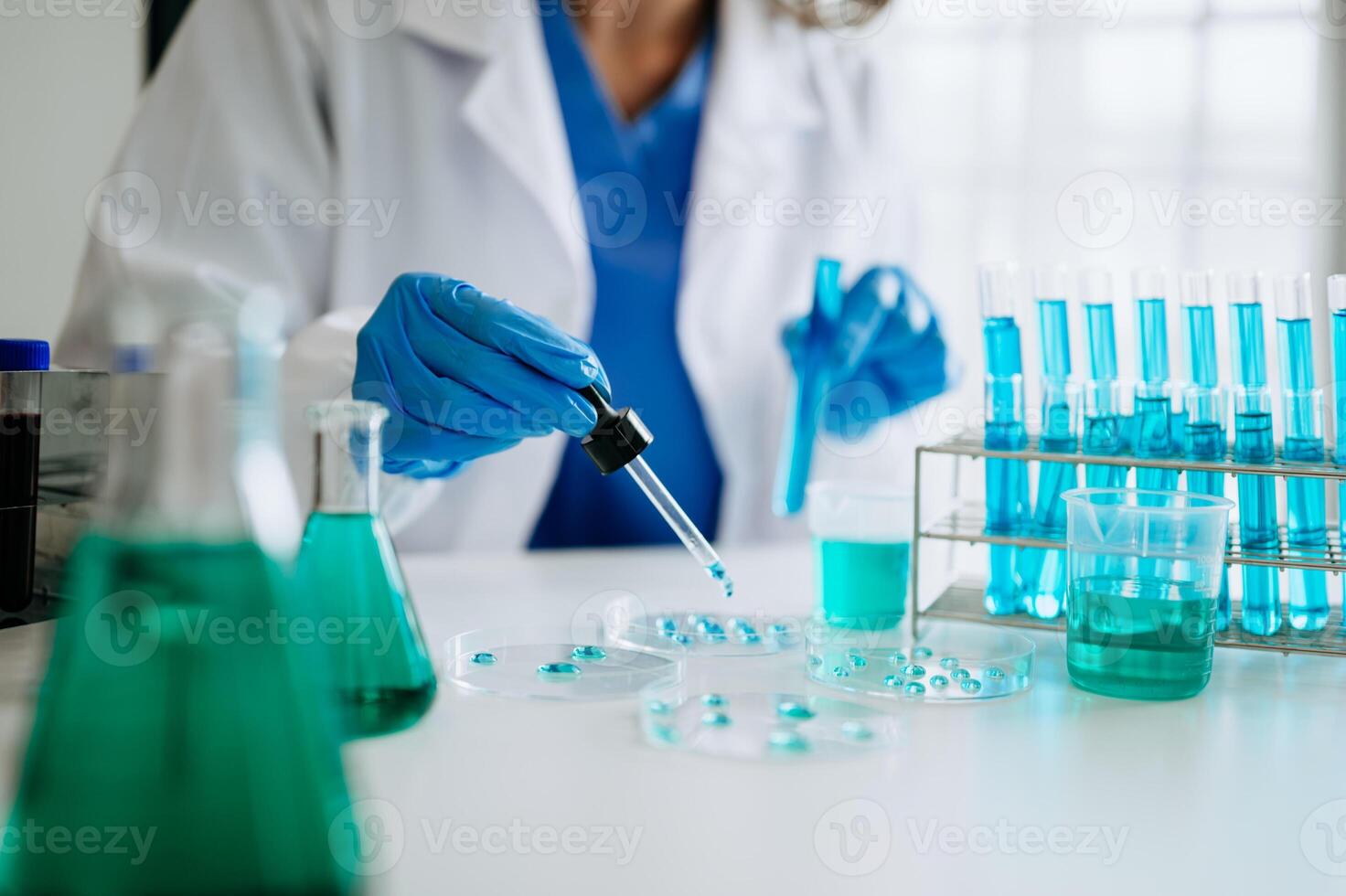 Scientist mixing chemical liquids in the chemistry lab. Researcher