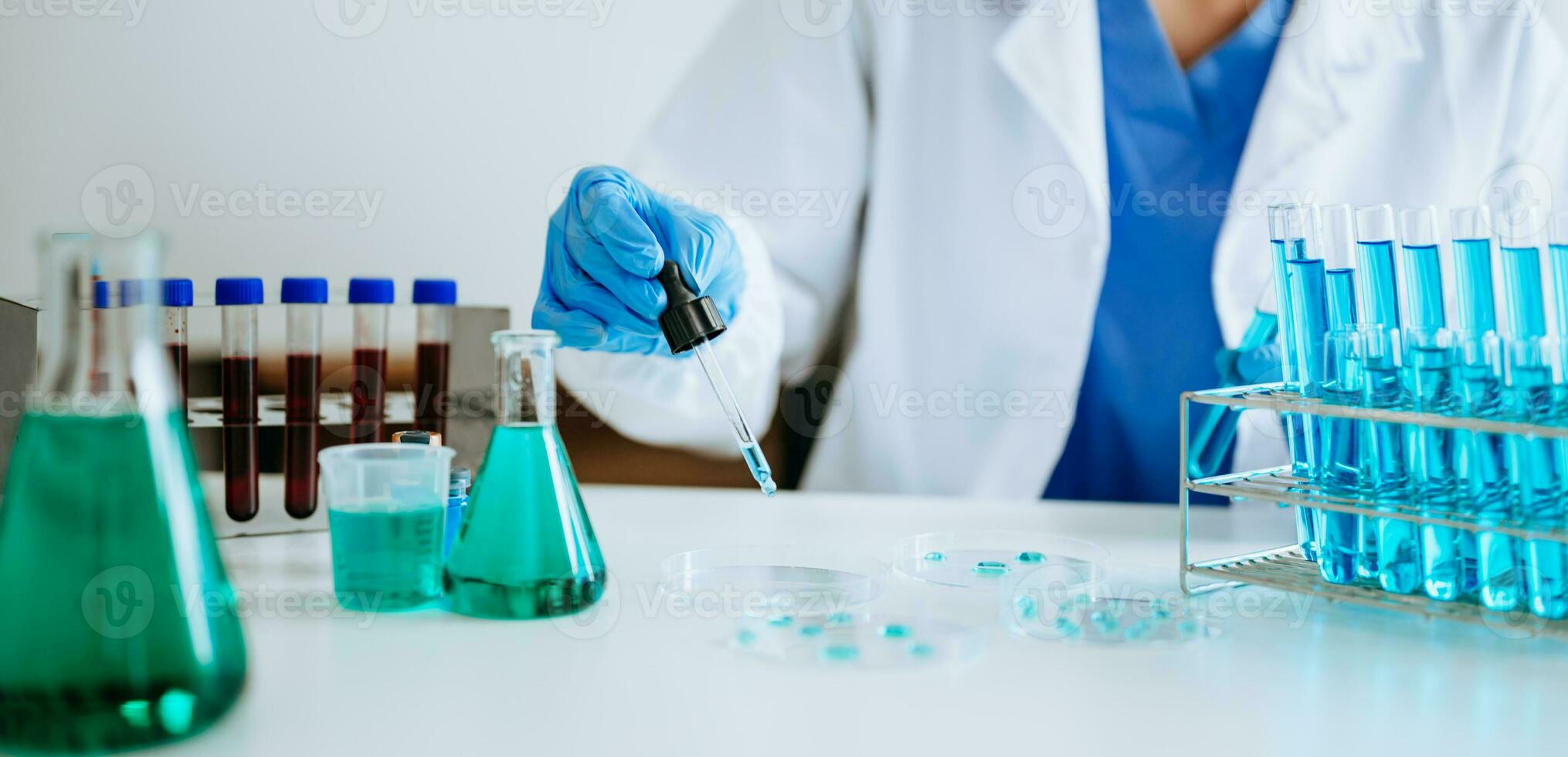 Scientist mixing chemical liquids in the chemistry lab. Researcher working in the chemical laboratory photo