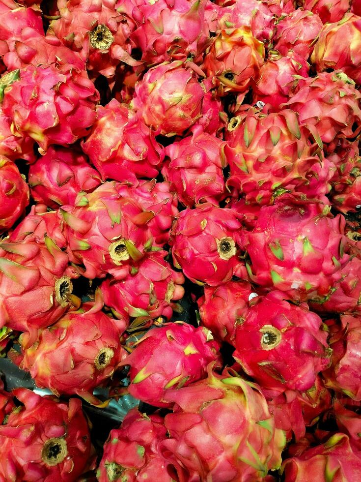 Fresh dragon fruit photographed with a cellphone in a supermarket, Pitaya or pitahaya is the fruit of several different cactus species photo