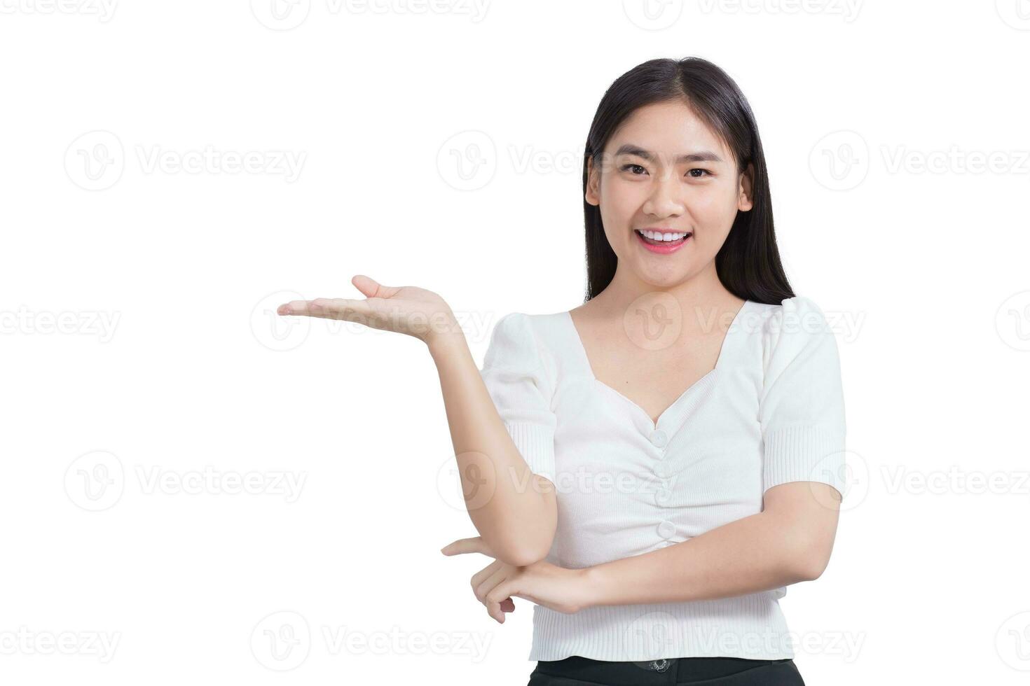 Portrait young Asian woman is smiling and shows her hands to present something isolated on white background. photo