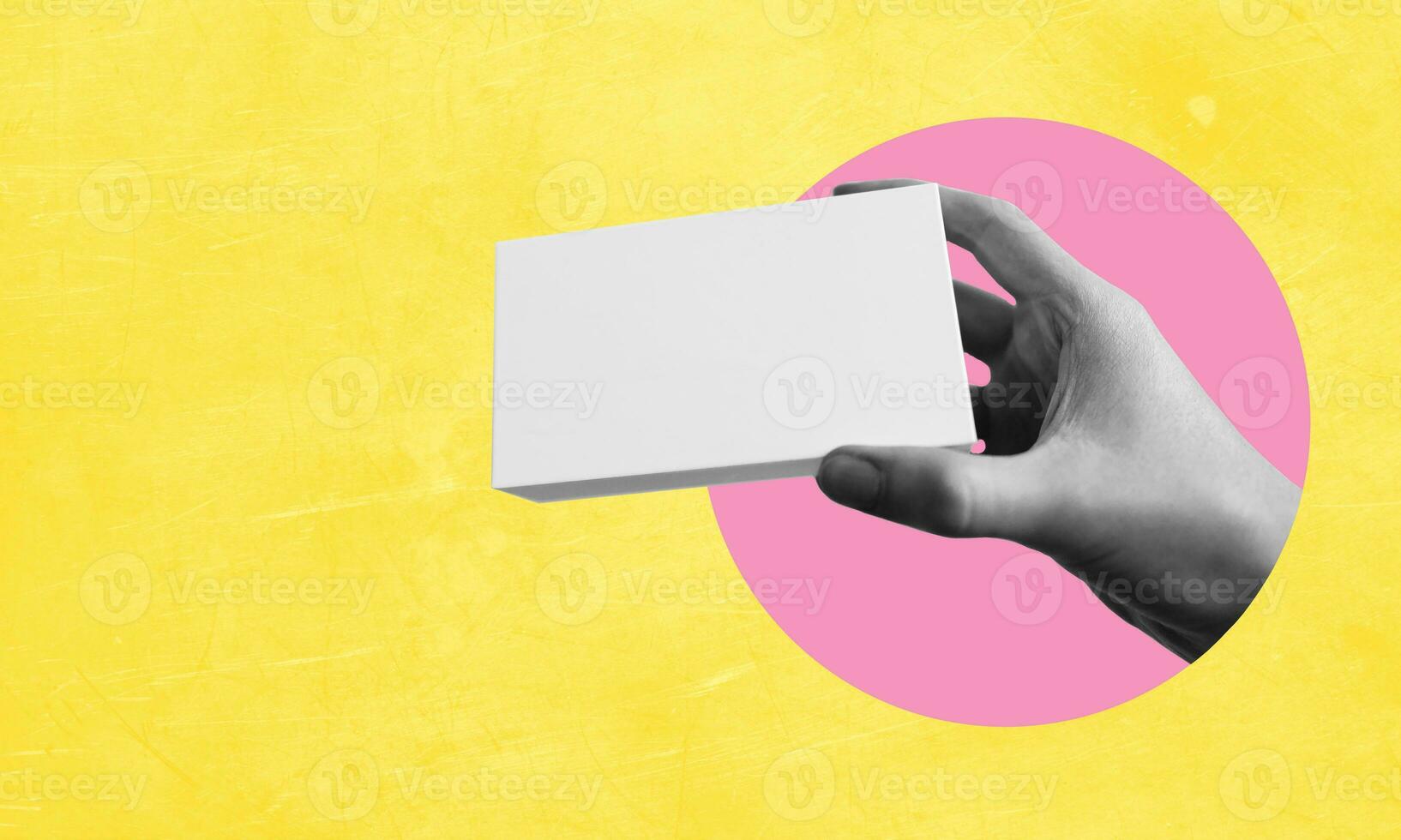 Human hand with white geometric speech bubble on yellow abstract background. Copy space for advertising, text, and design. photo