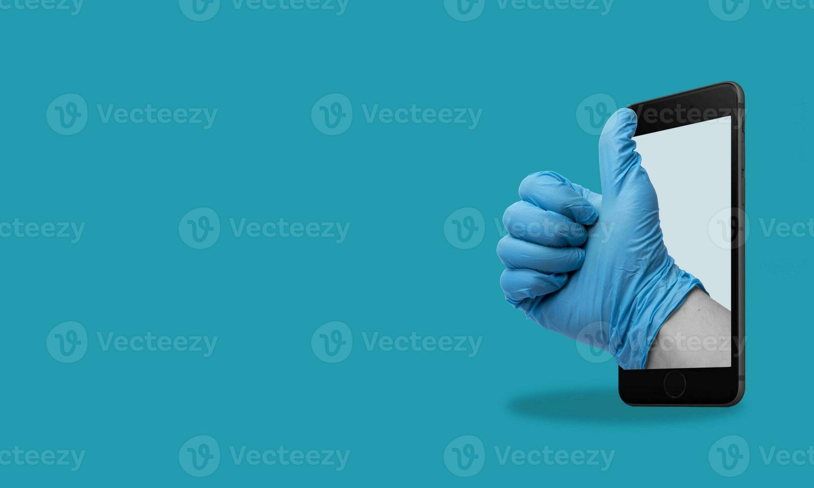 Art collage, Hand showing thumbs up gesture from a cell phone, on blue background with space for ads. photo