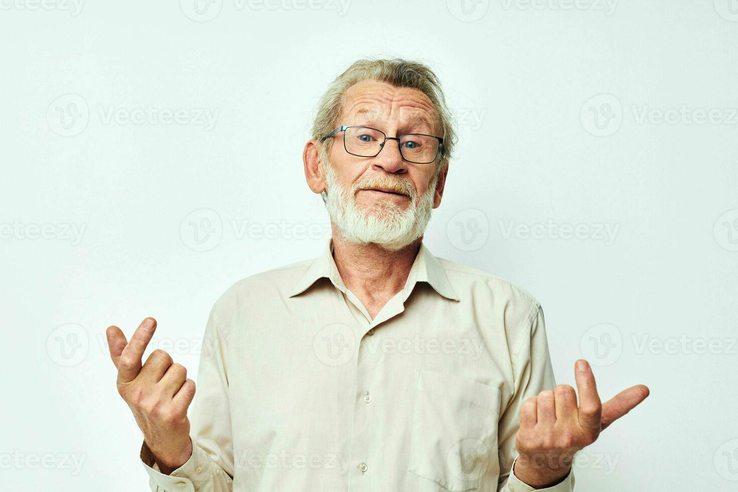 Senior grey-haired man with a gray beard in a shirt and glasses light background photo