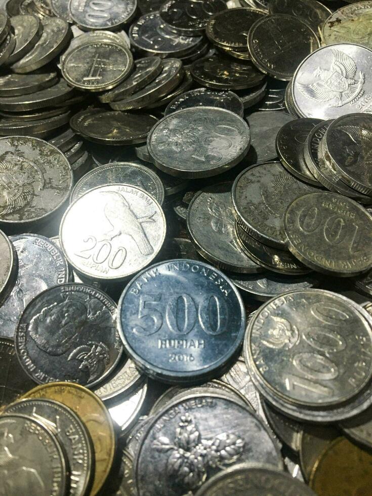 Shining and Glowing Stacked Collection of Old Indonesian Rupiah Coins photo