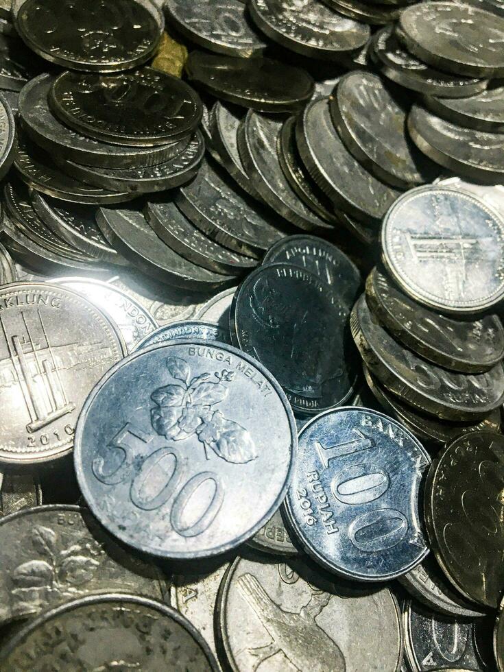 Shining and Glowing Stacked Collection of Old Indonesian Rupiah Coins photo