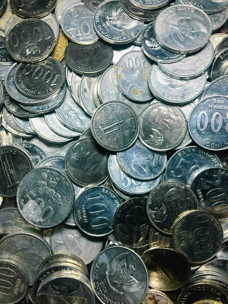 Shining and Glowing Stacked Collection of Old Indonesian Rupiah Coins photo