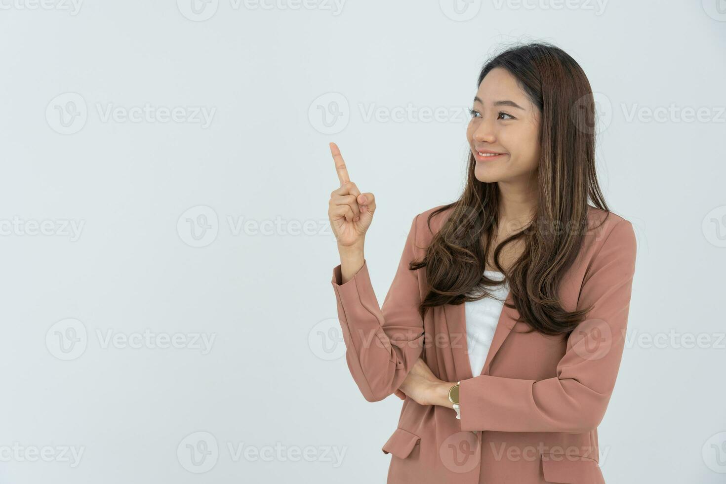 Portrait asian beautiful girl pointing blank space isolated background. Happy woman pointing on something. young female standing pointing finger sideways, billboard, introduction, advertisement, space photo