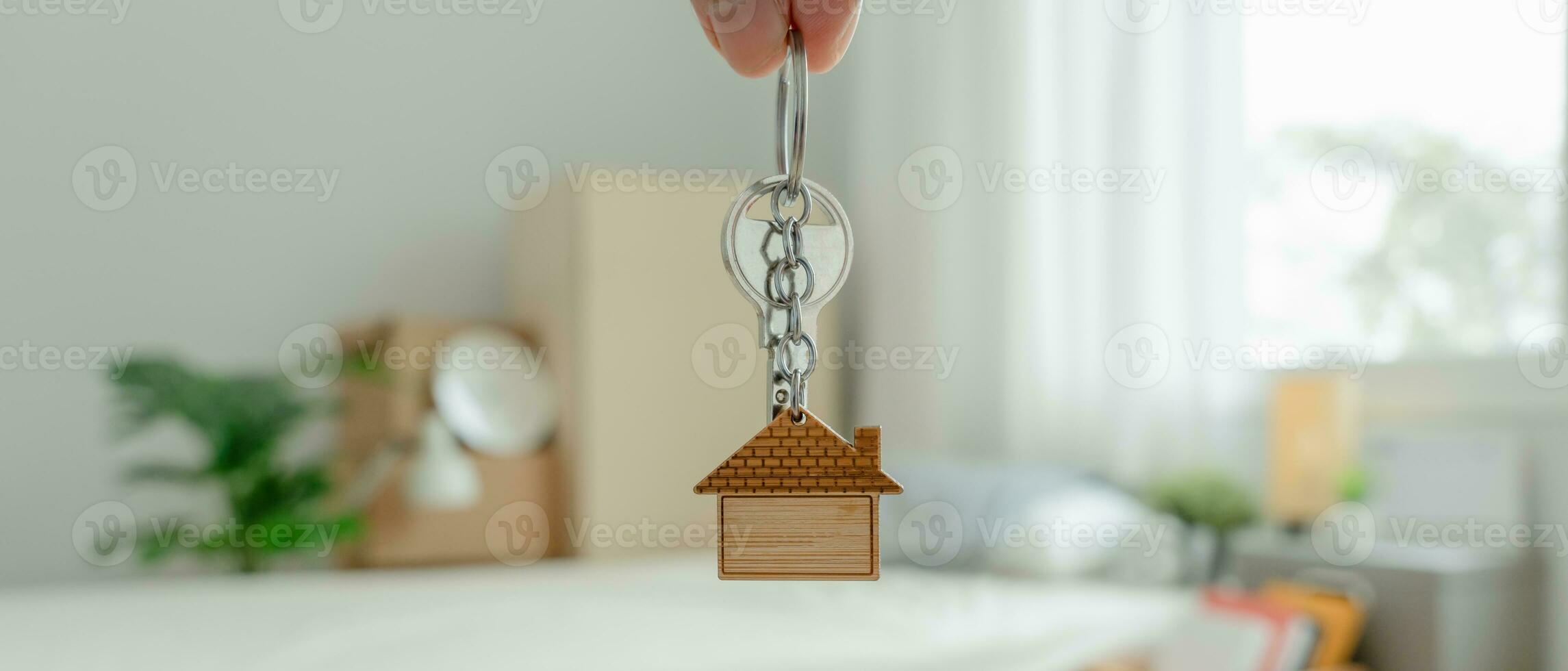 Moving house, relocation. Man hold key house keychain in new apartment. move in new home. Buy or rent real estate. flat tenancy, leasehold property, new landlord, investment, dwelling, loan, mortgage. photo