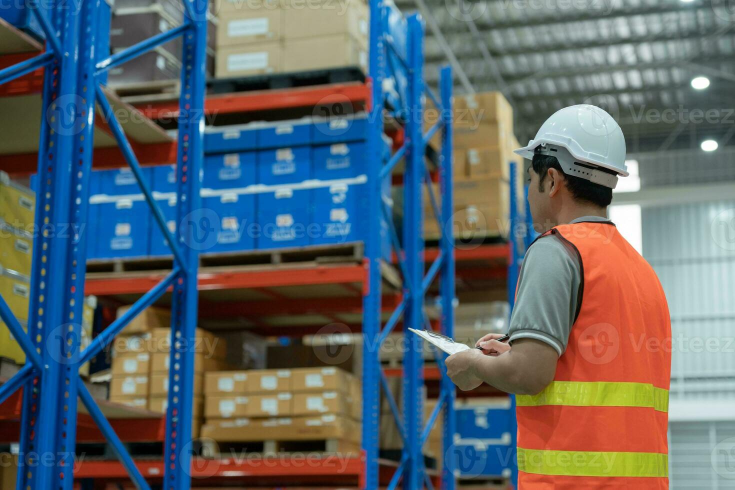 Asian male factory inspect and check inventory on warehouse, count stock product. Transport logistic business shipping, delivery to customers. inspection, storehouse, storage, factory, manage. photo