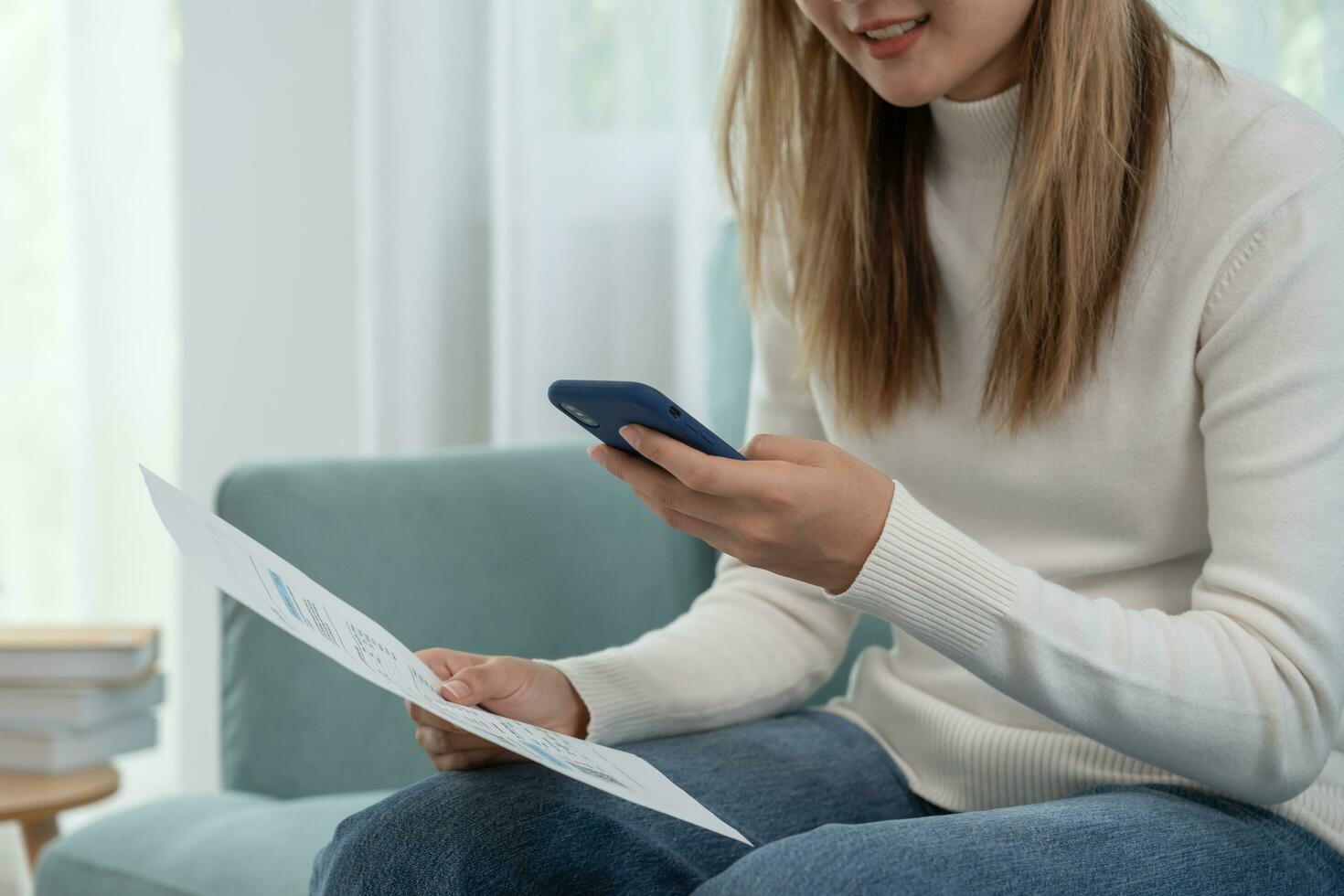 Modern woman use phone to scan barcode or QR codes to pay credit card bill after receive document invoice. payment, receive, paying electricity, digital payments without money, technology, scanning photo
