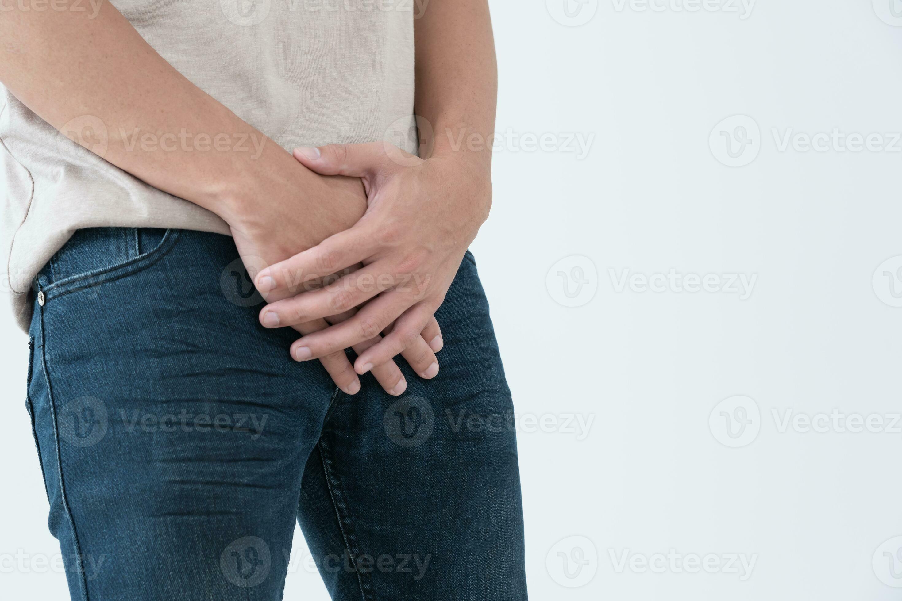 Man hold hand in front of private parts feeling from disease