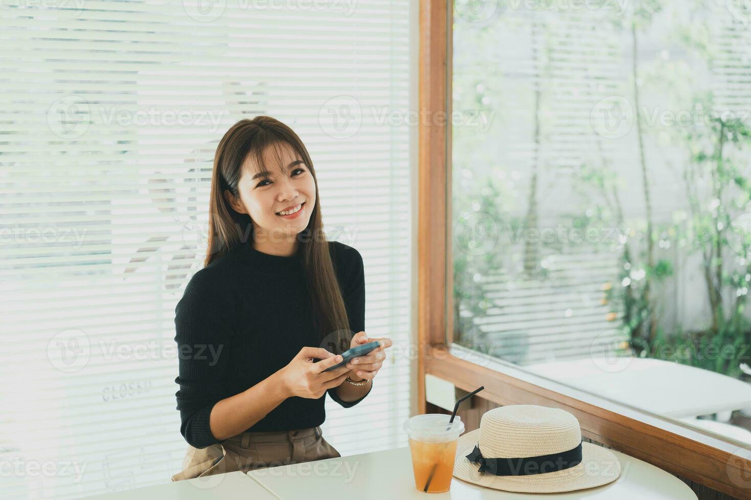 Asian working woman hold mobile phone text message, chat conversation or using social media. Businesswoman use smartphone browse web, read e-book, trade stocks. Communication technology concept. photo