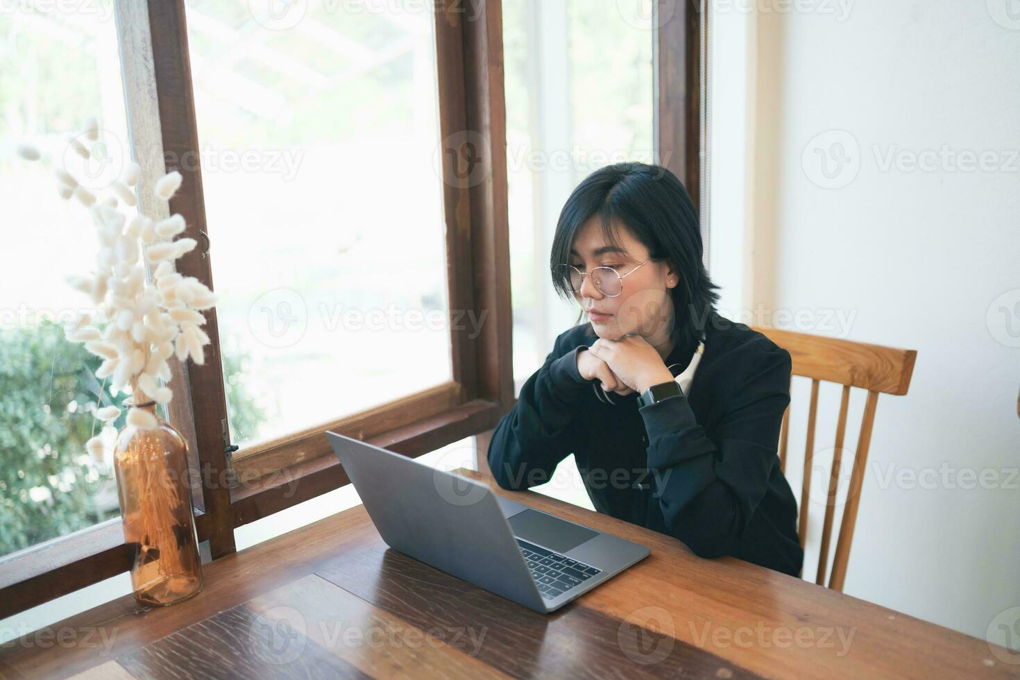Business freelance entrepreneur woman with white headphone working typing keyboard on laptop and on wooden table at the cafe coffee shop. Business technology concept. photo