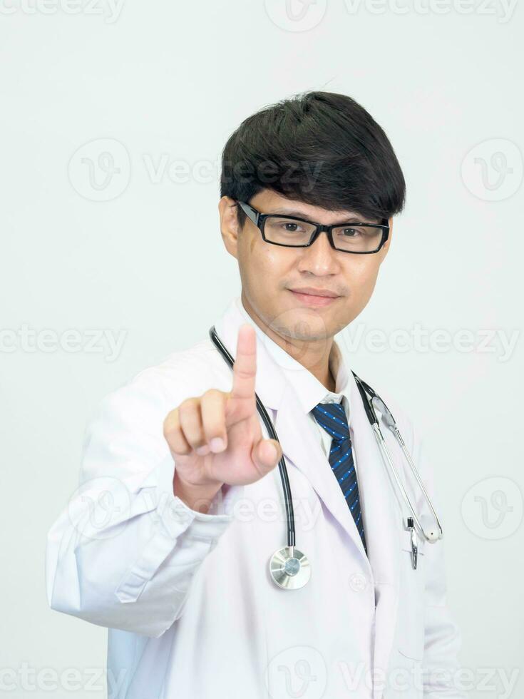 Asian man student scientist or doctor one person, wearing a white gown, standing, looking and smiling, white background with a stethoscope auscultating the heart around his neck. photo