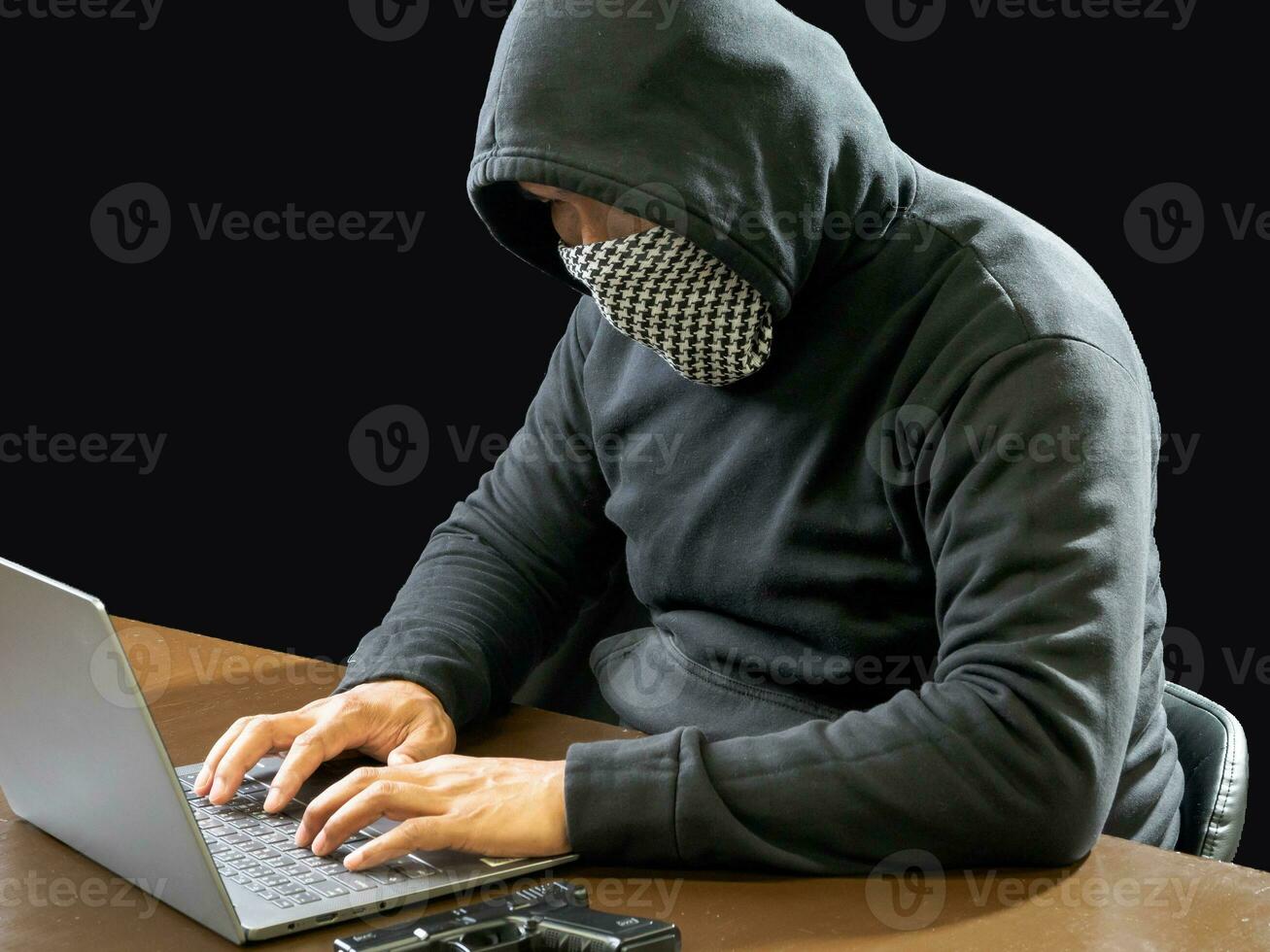 Hacker spy man wearing a black shirt, sitting on a chair and a table, is a thief, hands holding money, counting the amount obtained from hijacking or robbing, in a pitch-black room. photo