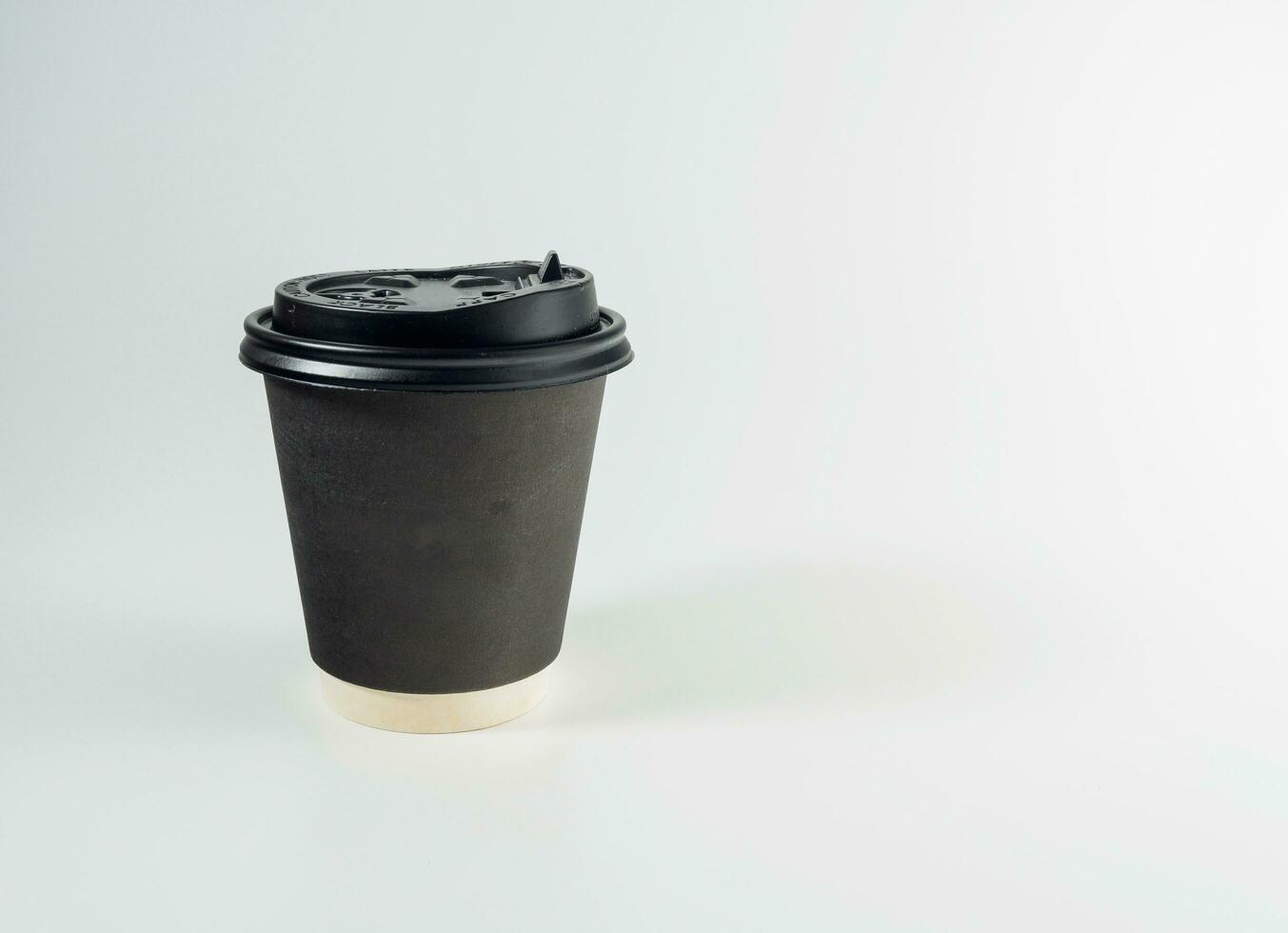 Front top view, black coffee paper cup black lid, filled with hot black coffee americano no sugar milk, ready to drink, refreshing. aroma awake fresh to work placed on a white isolated background photo