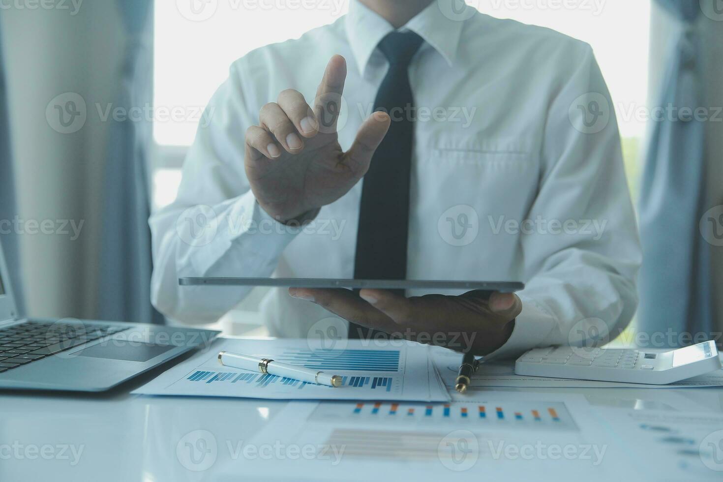 Close up businessman hand using calculator and working with laptop calculate about finance accounting at coffeeshop outdor.finance accounting concept photo