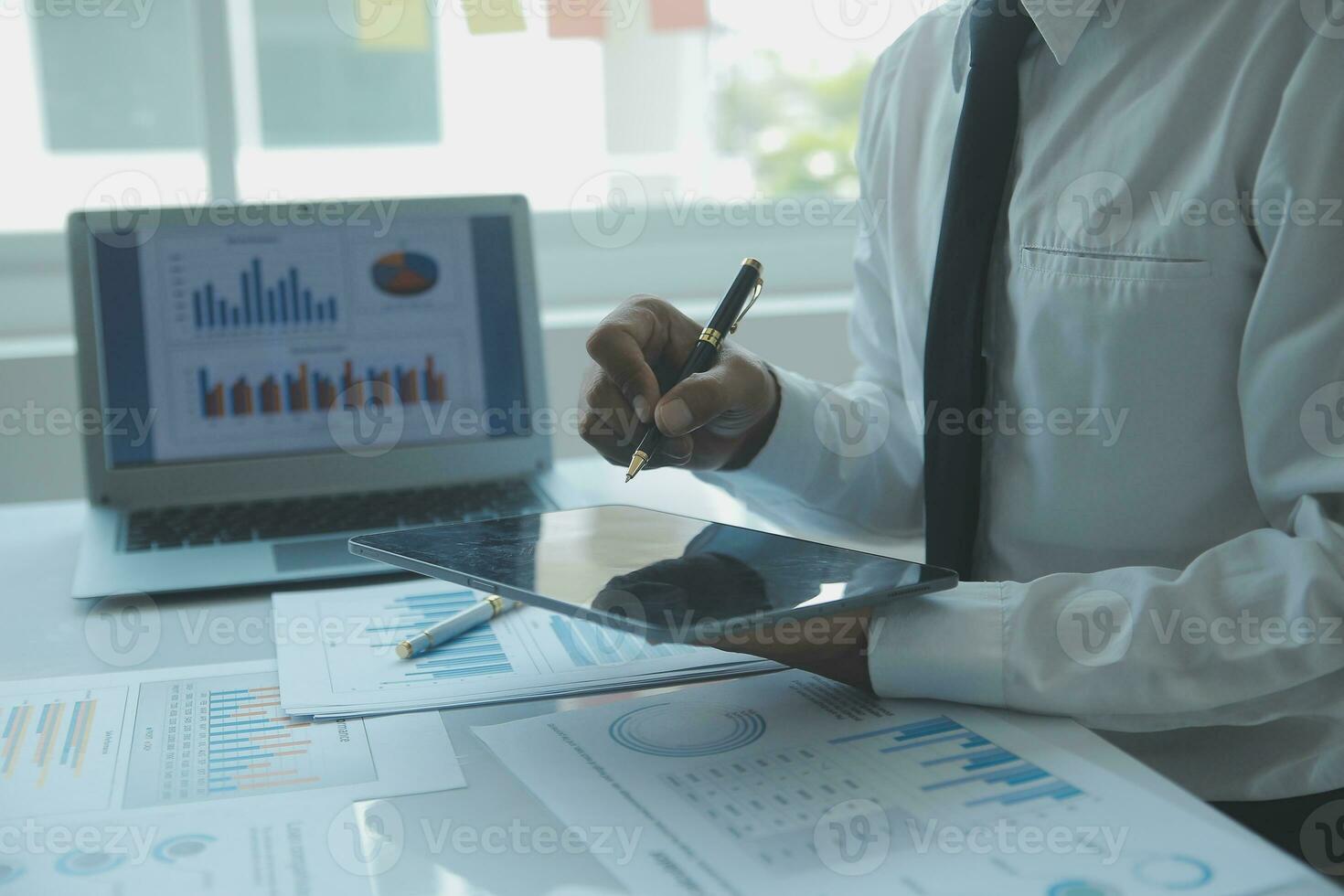 Close up businessman hand using calculator and working with laptop calculate about finance accounting at coffeeshop outdor.finance accounting concept photo