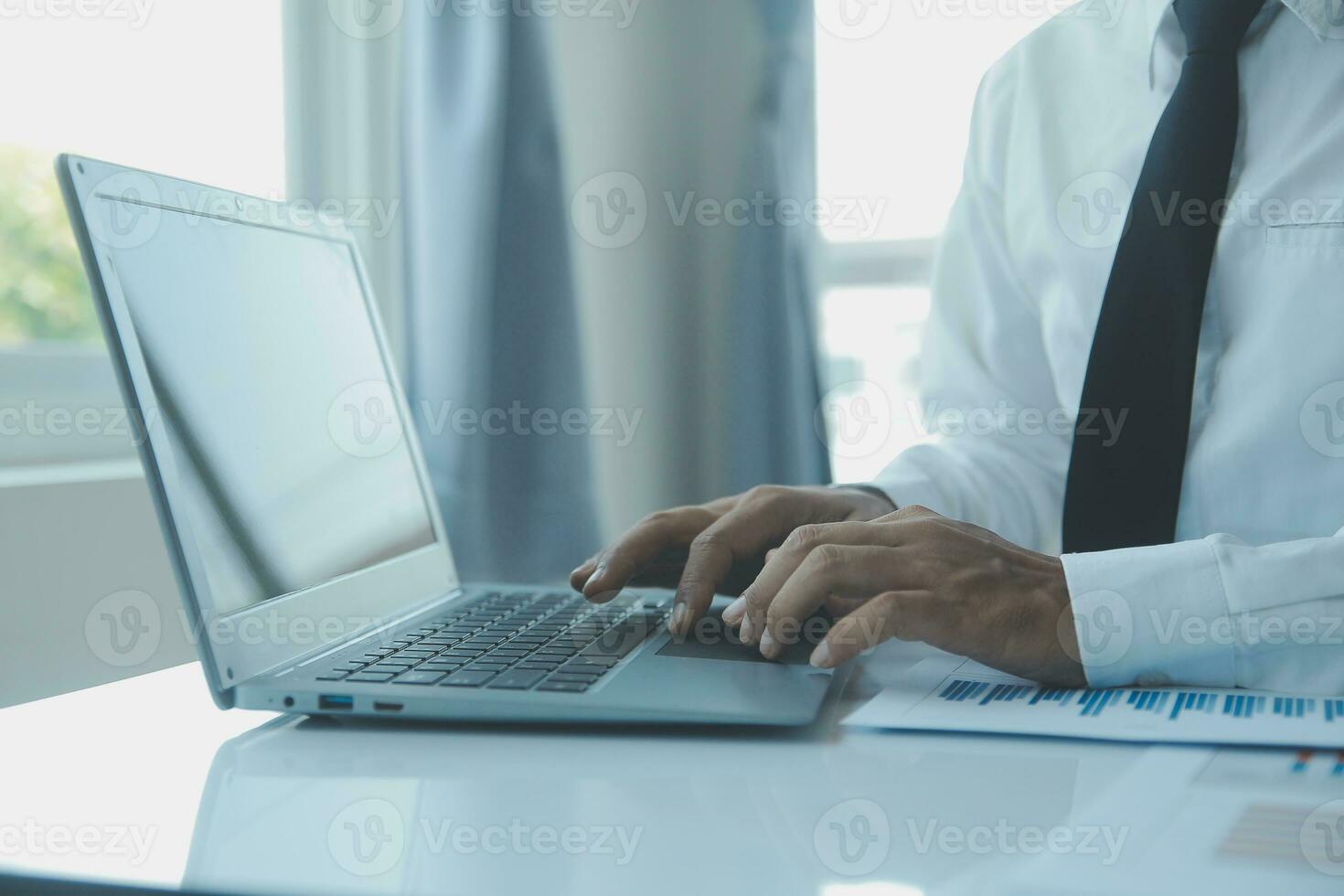 Close up businessman hand using calculator and working with laptop calculate about finance accounting at coffeeshop outdor.finance accounting concept photo