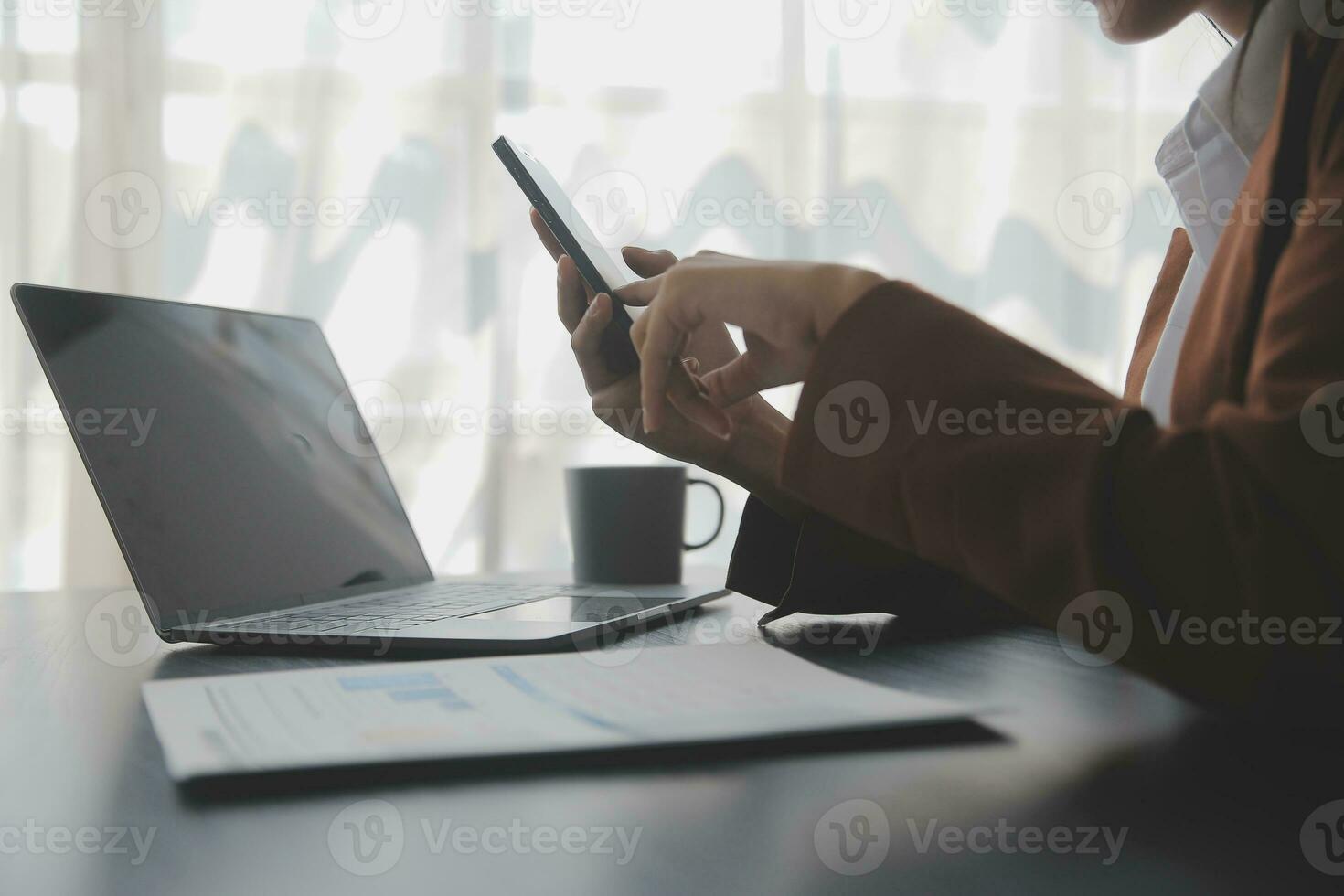 Asian Business woman using calculator and laptop for doing math finance on an office desk, tax, report, accounting, statistics, and analytical research concept photo