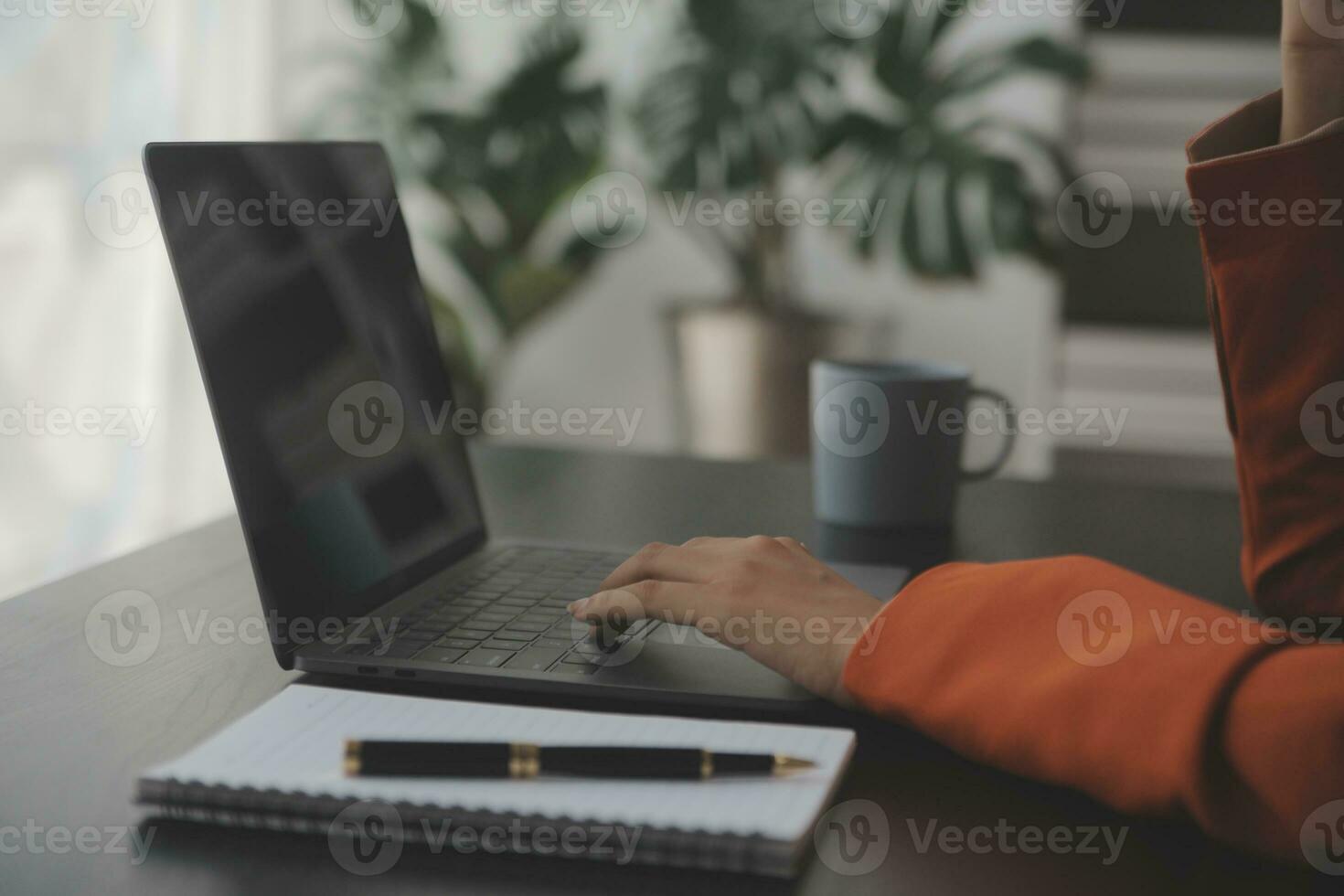 Asian Business woman using calculator and laptop for doing math finance on an office desk, tax, report, accounting, statistics, and analytical research concept photo