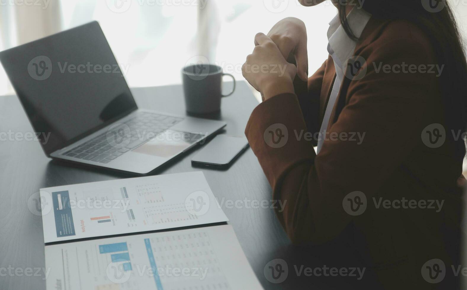 Asian Business woman using calculator and laptop for doing math finance on an office desk, tax, report, accounting, statistics, and analytical research concept photo
