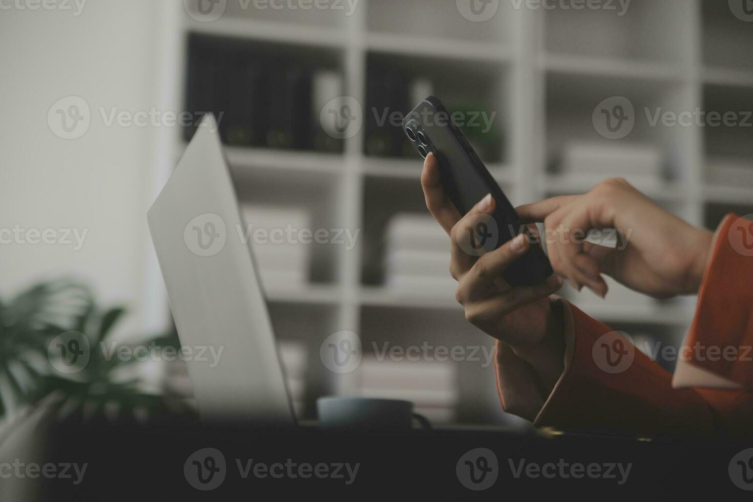 Asian Business woman using calculator and laptop for doing math finance on an office desk, tax, report, accounting, statistics, and analytical research concept photo