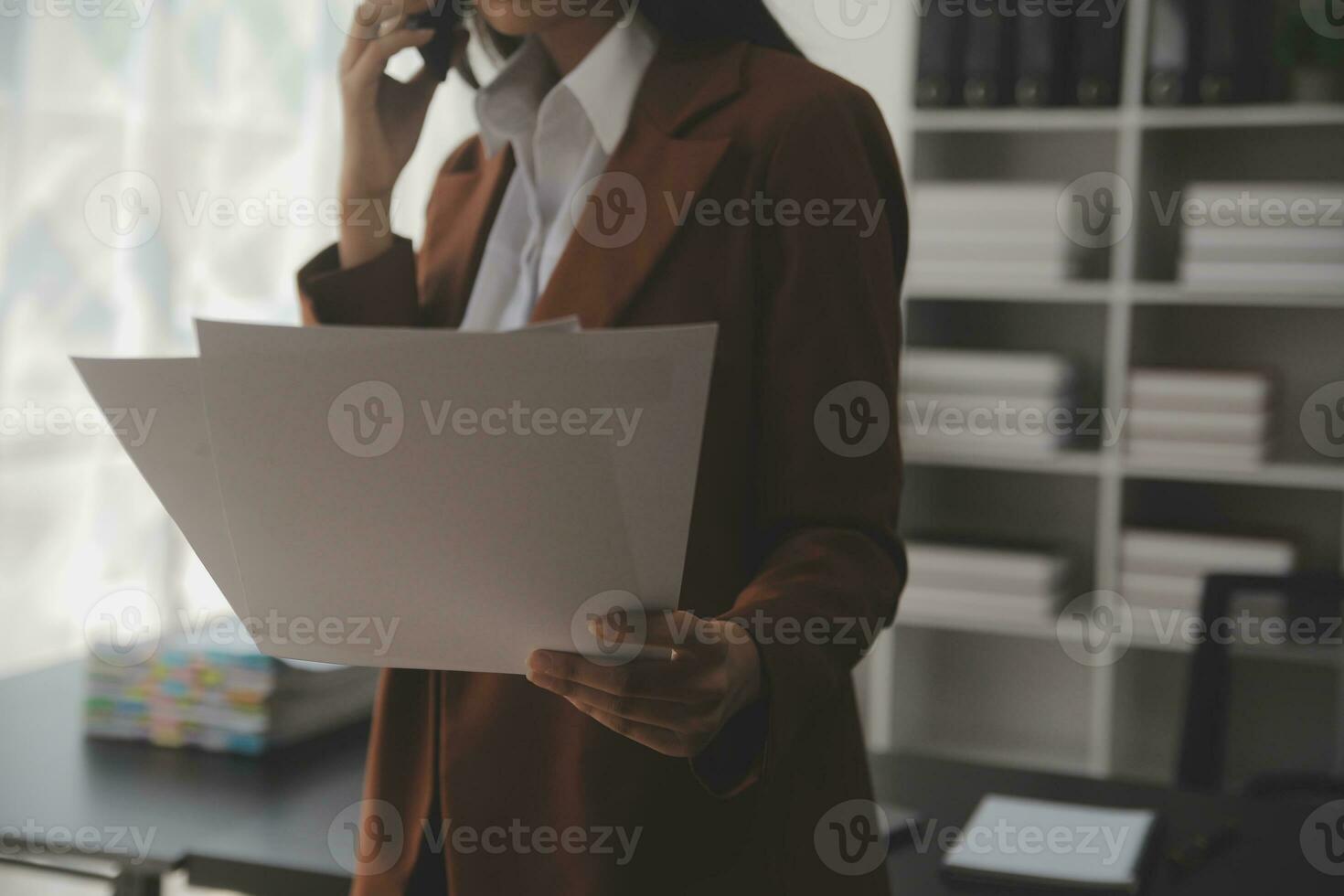 Asian Business woman using calculator and laptop for doing math finance on an office desk, tax, report, accounting, statistics, and analytical research concept photo