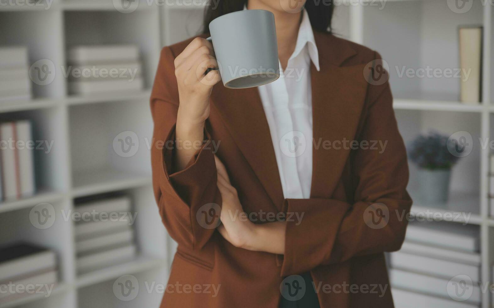 Asian Business woman using calculator and laptop for doing math finance on an office desk, tax, report, accounting, statistics, and analytical research concept photo