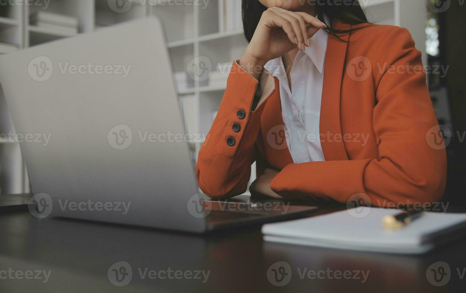 Asian Business woman using calculator and laptop for doing math finance on an office desk, tax, report, accounting, statistics, and analytical research concept photo