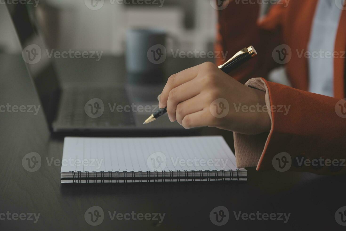 Asian Business woman using calculator and laptop for doing math finance on an office desk, tax, report, accounting, statistics, and analytical research concept photo