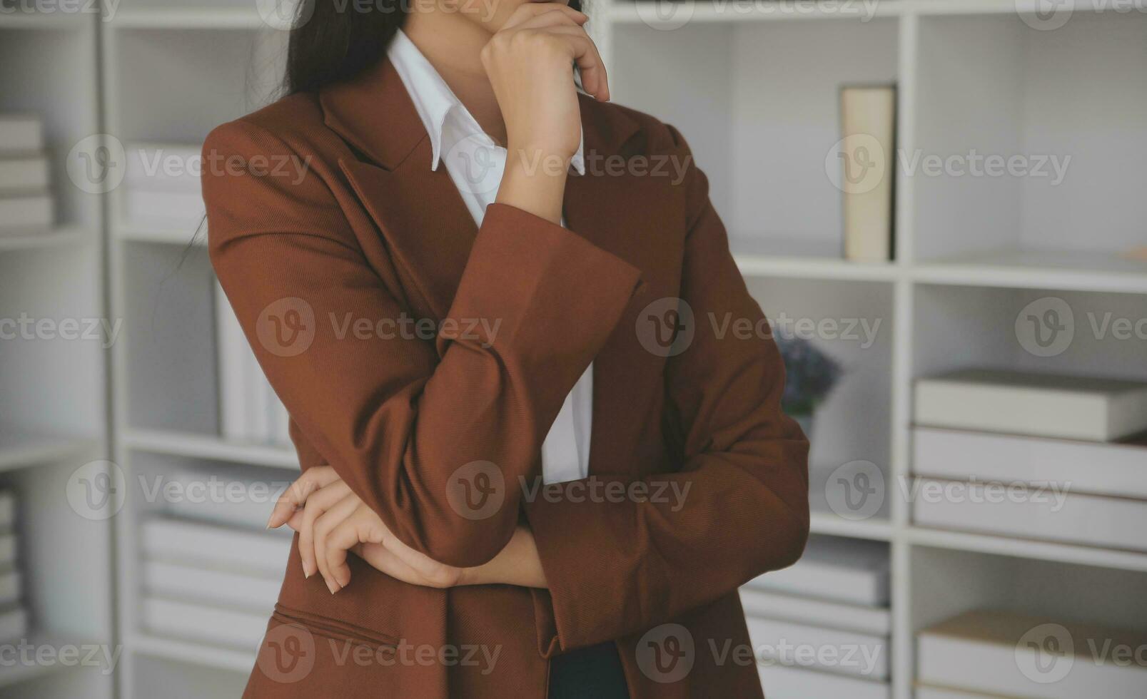 Asian Business woman using calculator and laptop for doing math finance on an office desk, tax, report, accounting, statistics, and analytical research concept photo