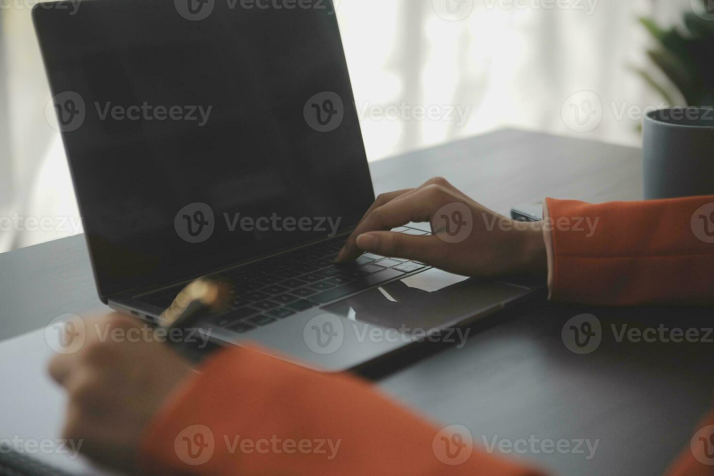Asian Business woman using calculator and laptop for doing math finance on an office desk, tax, report, accounting, statistics, and analytical research concept photo