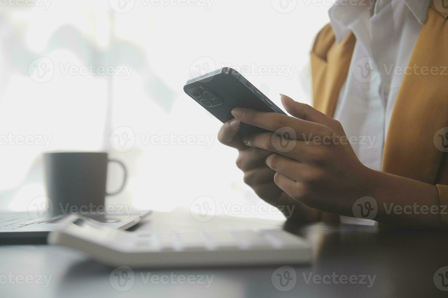 Asian Business woman using calculator and laptop for doing math finance on an office desk, tax, report, accounting, statistics, and analytical research concept photo
