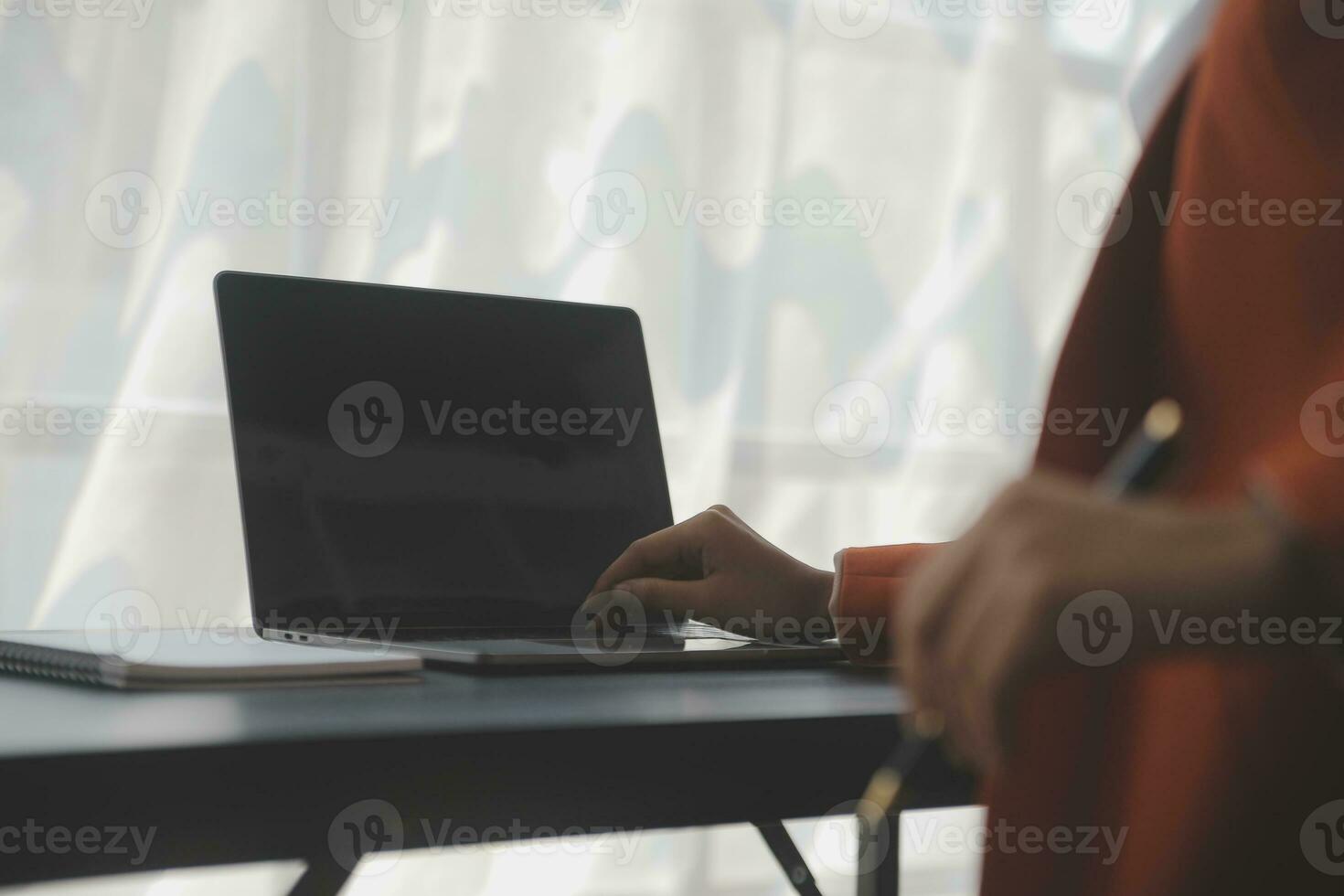 Asian Business woman using calculator and laptop for doing math finance on an office desk, tax, report, accounting, statistics, and analytical research concept photo