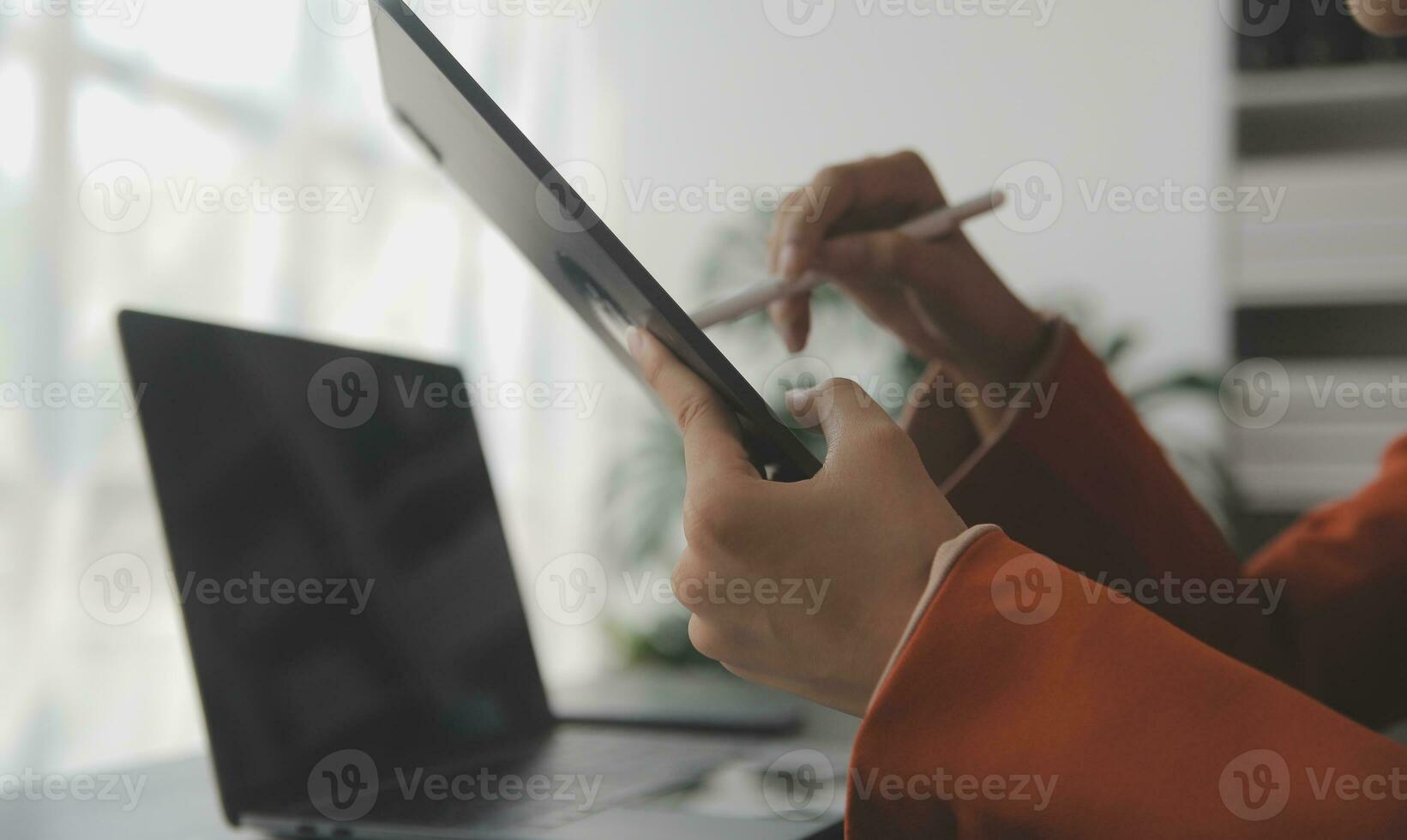 Asian Business woman using calculator and laptop for doing math finance on an office desk, tax, report, accounting, statistics, and analytical research concept photo